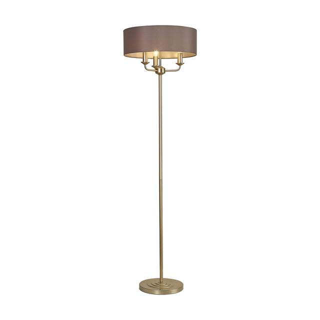 Banyan 3 Light E14 floor lamp with a wide grey fabric drum shade on champagne gold candelabra arms, slender stem and round stepped base, shown on a plain white background.