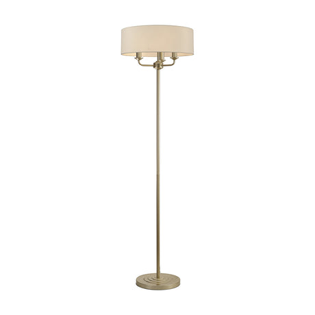 Banyan 3 Light E14 floor lamp with a wide 45cm ivory pearl fabric shade on a slim champagne gold stem and round stepped base, shown on a plain white background.
