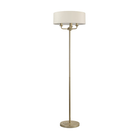 Banyan 3 Light E14 Floor Lamp with a broad 45cm nude beige drum shade on a slender champagne gold stem and stepped round base, shown on a plain white background.