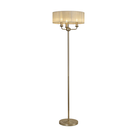 Banyan 3 Light E14 Floor Lamp with slim champagne gold stem, round base and wide cream fabric drum shade, shown on a plain white background.