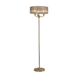 Banyan 3 Light E14 Floor Lamp with a slim champagne gold column and 45cm grey organza drum shade housing three candle lights, shown on a plain white background.