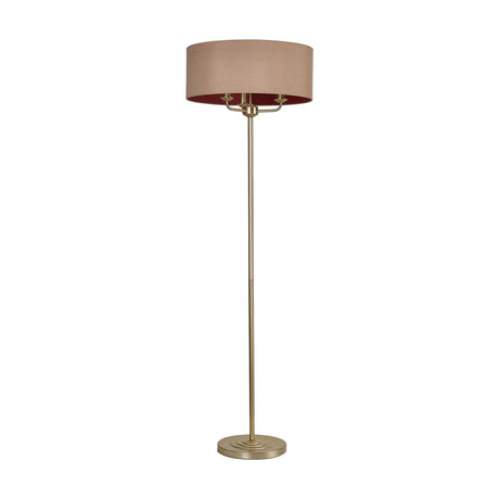 Banyan 3 Light E14 floor lamp with antique gold metal stem and round base, topped with a wide champagne fabric drum shade over three candle lights, shown on a plain white background.
