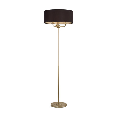 Banyan 3 Light E14 floor lamp with a black drum fabric shade on a slim champagne gold stem and round stepped base, shown on a plain white background.