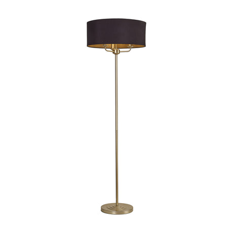 Banyan 3 Light Floor Lamp with 50cm midnight black drum shade and champagne gold interior, tall slender champagne gold stem and round base, on a plain white background.