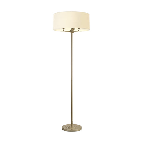Banyan 3 Light E14 floor lamp with slim champagne gold stem, stepped round base, and a 50cm ivory pearl drum shade, shown on a plain white background.