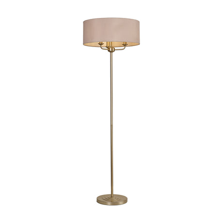Banyan 3 Light E14 Floor Lamp with a 50cm nude beige drum shade on a slender champagne gold stem and stepped round base, shown on a plain white background.