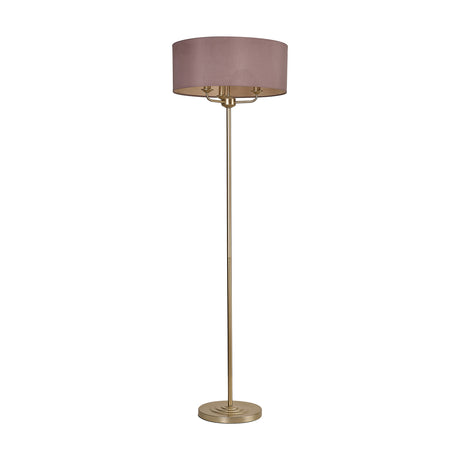 Banyan 3 Light E14 floor lamp with a wide taupe drum shade over three candle lights, champagne gold stem and stepped round base, on a plain white background.