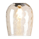 Cawdor wine glass wall light with a champagne-tinted glass shade, wide at the rim and tapering to a matt black wall plate, lit E27 bulb visible, shown on a white background.