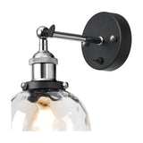 Cawdor Wine Glass Wall Light with clear dimpled glass shade, polished chrome fitting and black backplate, shown with visible E27 filament bulb on a white background.