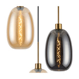 Pendant light with amber and smoke glass oval shades on antique gold fittings, shown individually with visible filament bulbs against a white background.