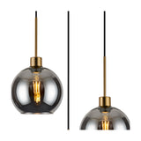 Lori pendant light with a single open-mouth smoke glass globe on an antique gold fitting, showing the exposed bulb, against a plain white background.