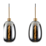 Two chrome pendant lights from the Lori 3 Light Linear Pendant, each with an oval glass shade on an antique gold ceiling mount and black cable, shown on a white background.