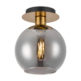 Lori E27 flush ceiling light with a round antique gold ceiling plate, brass fitting, and open-mouthed smoke-tinted glass globe shade, shown lit against a plain white background.