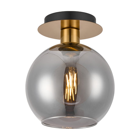 Lori E27 flush ceiling light with a round antique gold ceiling plate, brass fitting, and open-mouthed smoke-tinted glass globe shade, shown lit against a plain white background.