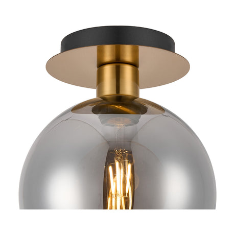 Lori E27 flush ceiling light with a black ceiling plate, antique gold fitting, and smoke-tinted glass globe shade revealing a visible filament bulb, shown on a white background.