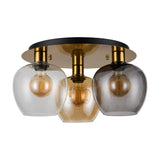 Lori 3-light flush ceiling light in antique gold with amber, clear, and smoke globe glass shades, filament bulbs, and a round black and gold ceiling plate.