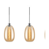 Lori 3 Light Trapezium Pendant Light in amber glass with polished chrome fittings, showing two lit oval shades on black cables against a plain white background.
