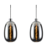 Two Lori E27 chrome pendant lights with trapezium glass shades and exposed filament bulbs, each hung from a slim polished chrome cord and mount on a white background.
