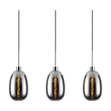 Lori pendant light showing three polished chrome trapezium glass shades with visible filament bulbs, suspended on black cables against a white background.