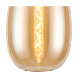Close-up of the Lori E27 flush ceiling light's amber glass shade with visible spiral filament bulb, set against a polished chrome ceiling plate.