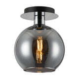 Lori E27 open mouth flush ceiling light with a round chrome globe shade and polished chrome ceiling plate, lit bulb visible inside, shown on a plain white background.