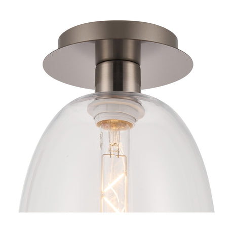 Close-up of the Lori flush ceiling light, showing a satin nickel ceiling plate and E27 bulb holder within a clear curved trapezium glass shade, set against a white background.