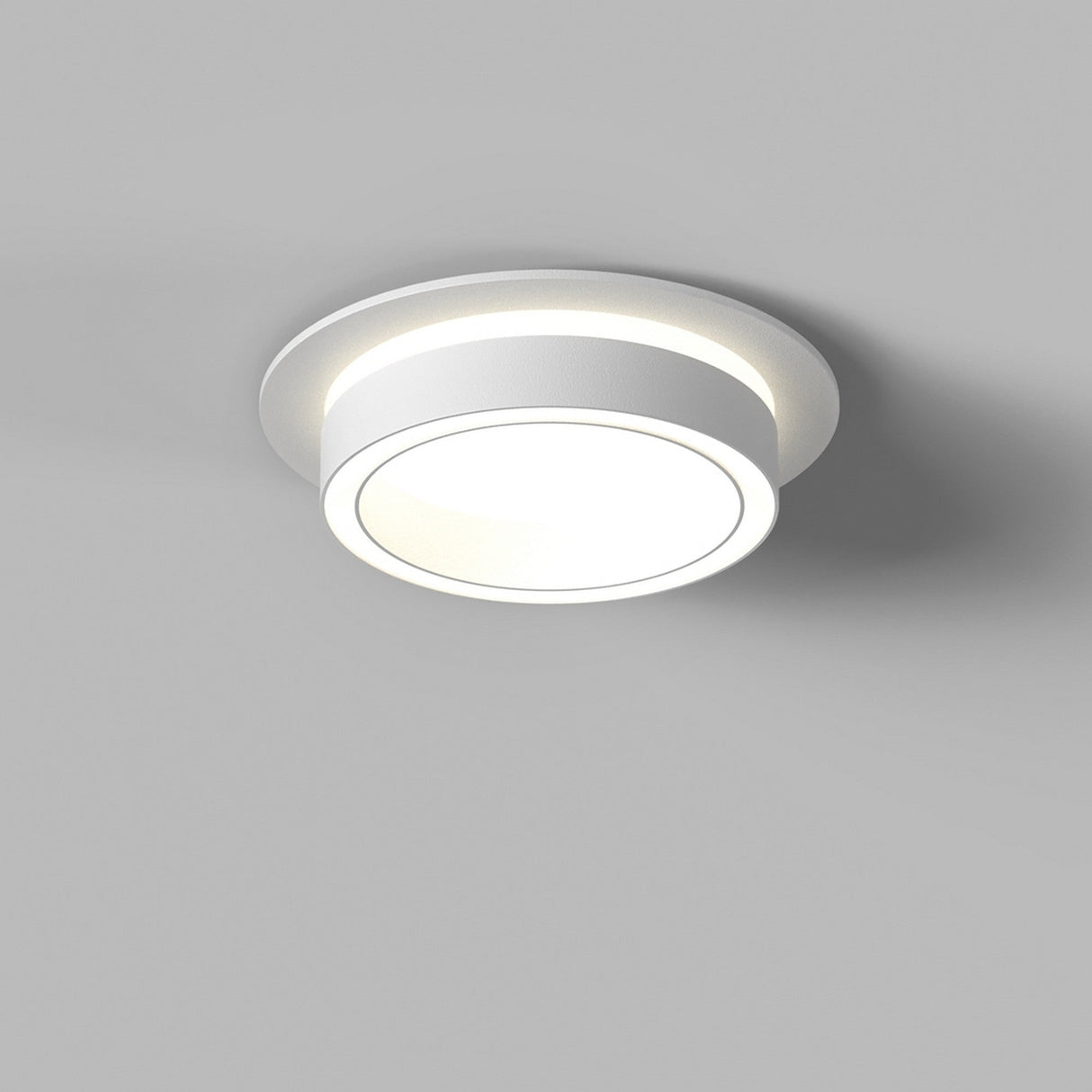 Angled view of Orlo Fixed Round Recessed Downlight in White, capturing its simple and functional design.