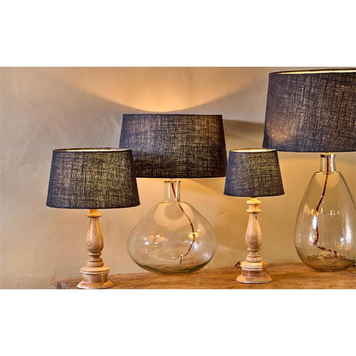 Dia Large Jute Lampshade in ink, a tapered drum shade with textured dark blue-black weave, shown on wooden table lamps in a lit room setting.