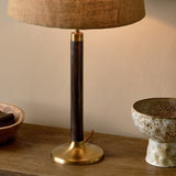 Digha Wooden Table Lamp Base in dark stained mango wood with antique brass cup and round foot, paired with a linen shade, styled on a wooden sideboard beside ceramic bowls.