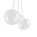Niori Diverso 3 Light LED Cluster Pendant with three clear blown-glass globes in varying sizes hanging from slim cables against a white background.