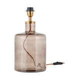 Edina small recycled glass table lamp base in smoke brown, a hammered bottle-shaped body with sloping shoulder, brass neck collar, and black E27 lampholder.