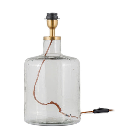 Edina Small Recycled Glass Table Lamp Base in clear hammered glass with a bottle-shaped body, brass collar and black bulb holder, shown on a plain white background.