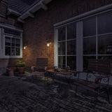 Wharf exterior wall light, shown in a garden setting