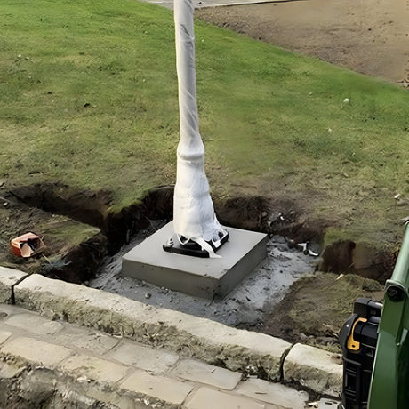 Medium Foundation Frame 150mm Square in galvanised steel, installed in a concrete base with a wrapped post above, set within an excavated garden lawn area.
