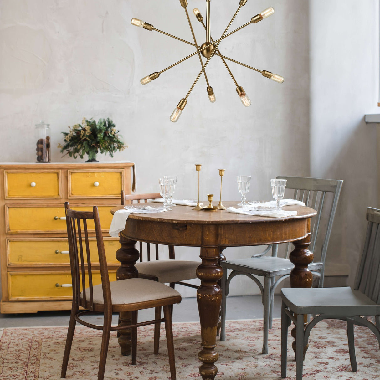 Centrix 10 light chandelier in gold finish, shown in a room setting