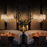 Icicle 10 light chandelier in brass finish, shown in a room setting