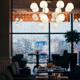 Vermeer 12 light chandelier in black and gold finish, shown in a room setting