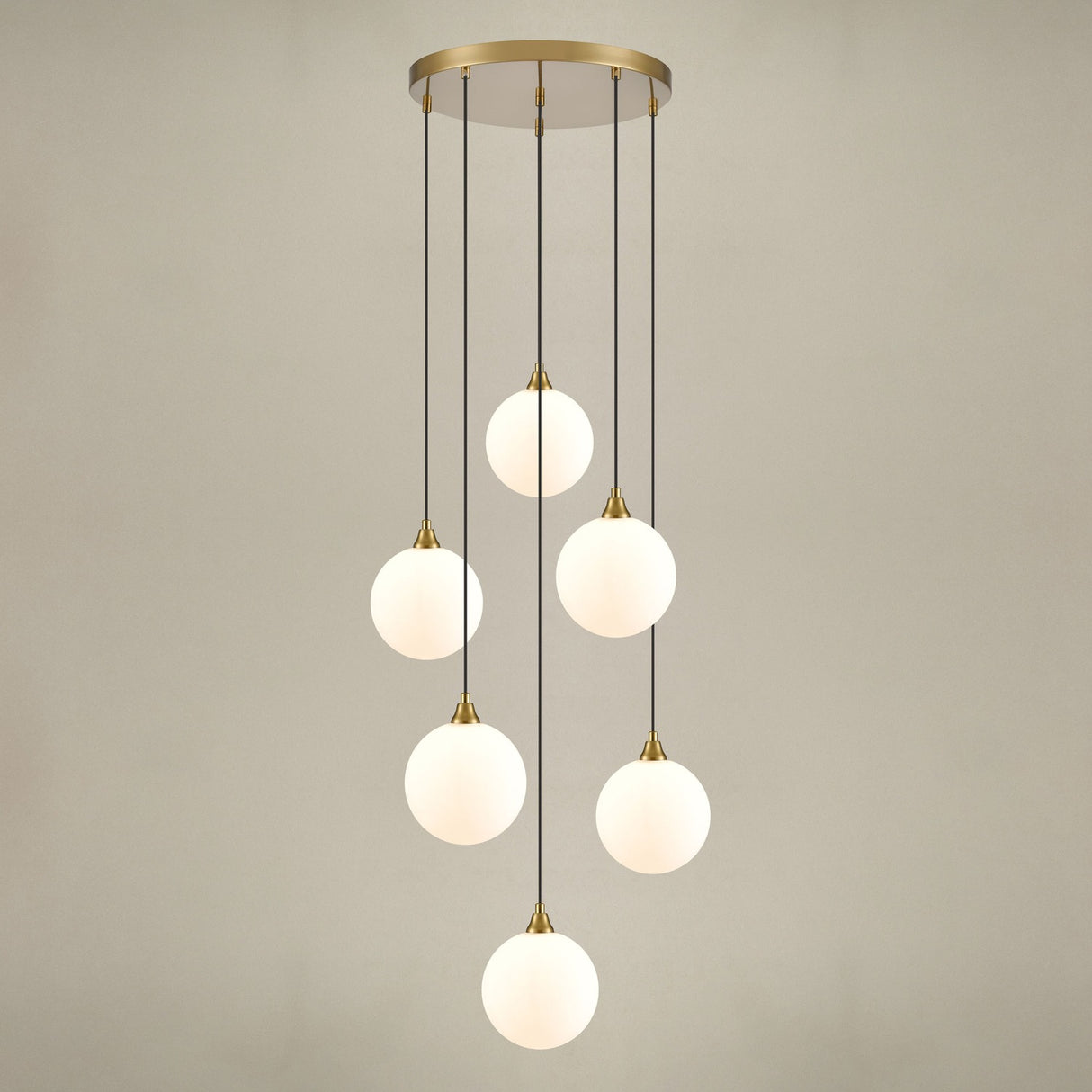 Perry 6 light pendant light in gold finish, shown on a dark background