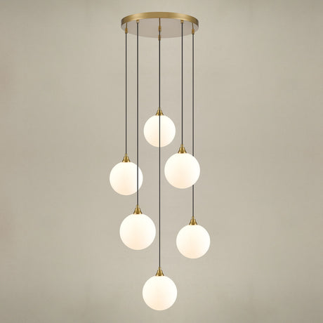 Perry 6 light pendant light in gold finish, shown on a dark background
