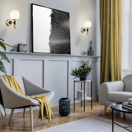 Axle ceiling light in black and brass finish, shown in a room setting
