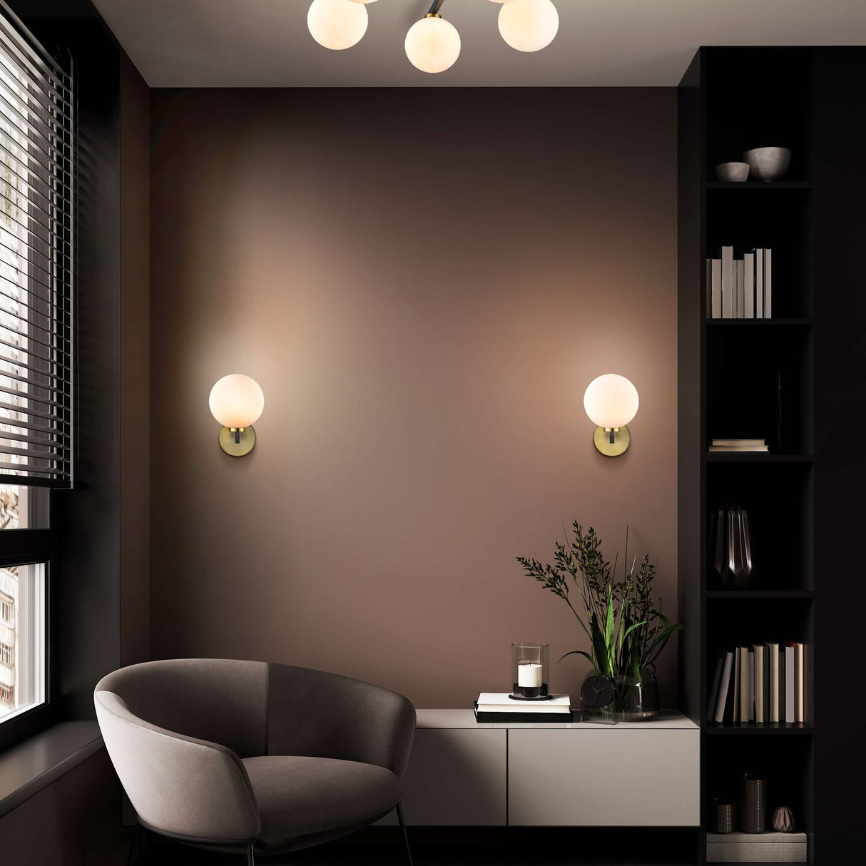 Lunar wall light in black and brass finish, shown in a room setting