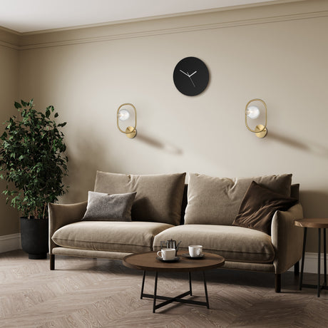 Trapeze wall light in brass finish, shown in a room setting