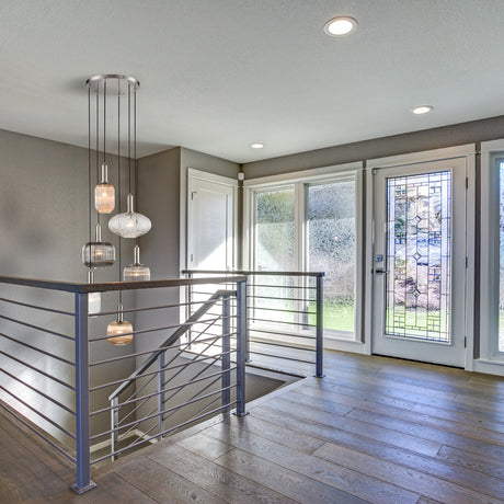 Mezcla 6 light pendant light in satin nickel finish, shown in a room setting
