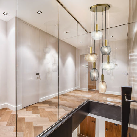 Mezcla 6 light pendant light in brass finish, shown in a room setting