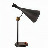 The Funk Table Lamp - Black features a modern design with a cone-shaped shade, an adjustable head, and gold accents at the joint and circular base, displayed against a plain white background.