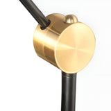 Close-up of the Funk Table Lamp - Black featuring a brushed gold cylindrical fixture, black metal arms, and a smooth round gold accent on top. Its adjustable head offers versatility, making it ideal for modern decor. Set against a plain white background.