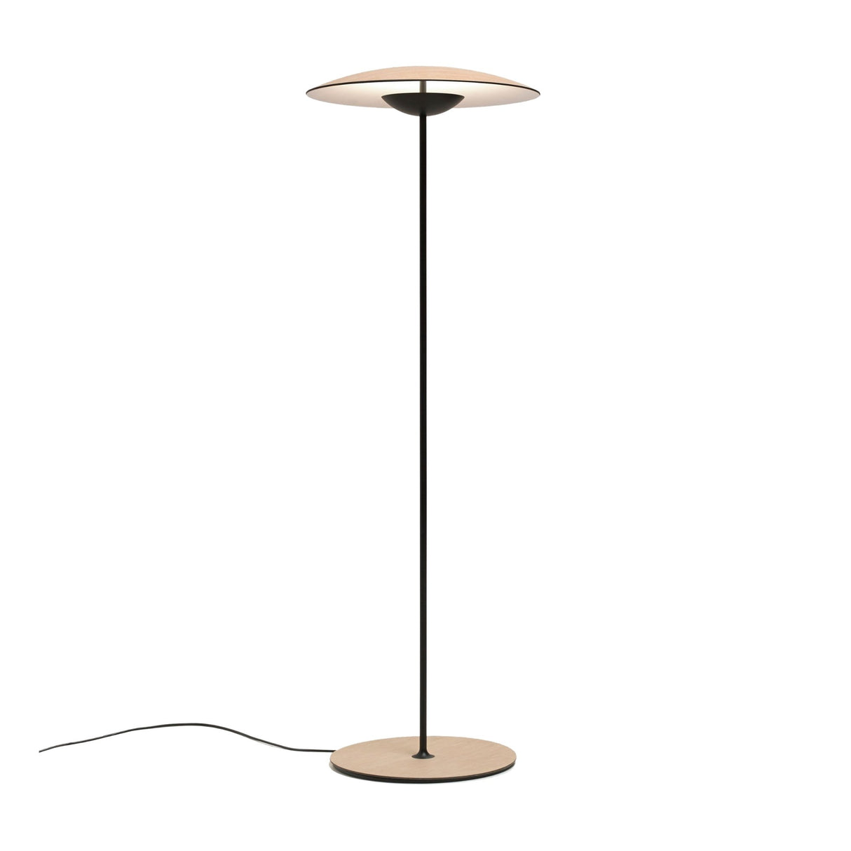 The Ex-Display Ginger LED Floor Lamp in Black & Oak features a thin black pole, round oak base, and flat circular oak shade. Its minimalist design includes a sleek black power cord—ideal for modern interiors.