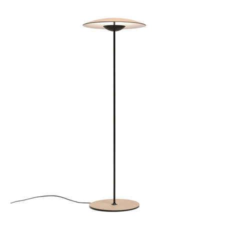 The Ginger LED Floor Lamp - Black & Oak features a slim black pole, flat round beige base, and matching circular shade—ideal for modern interiors.