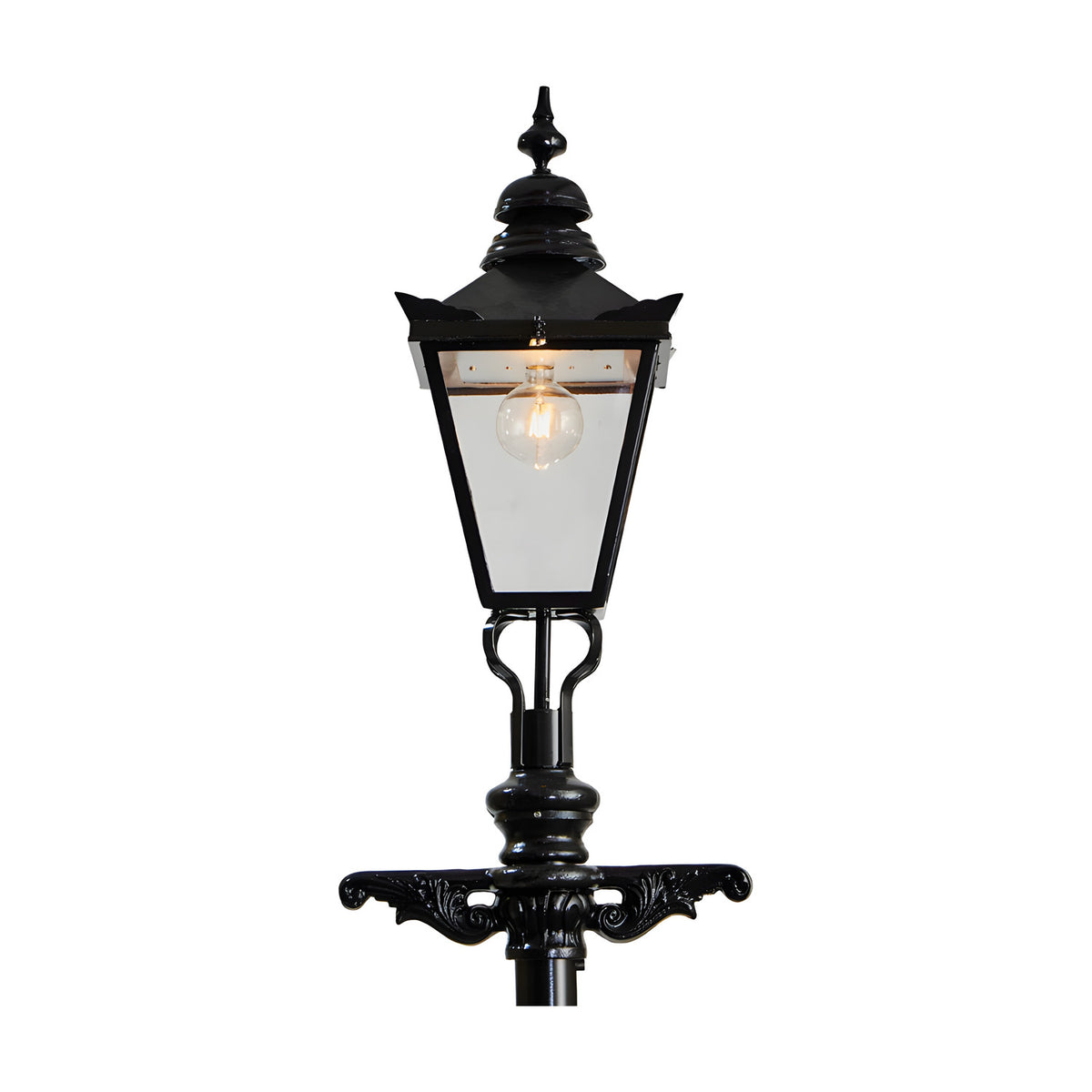 Victorian Cast Iron Lamp Post in black with a tapered four-sided lantern head, decorative finial, ornate scrollwork bracket, and exposed bulb, shown against a plain white background.
