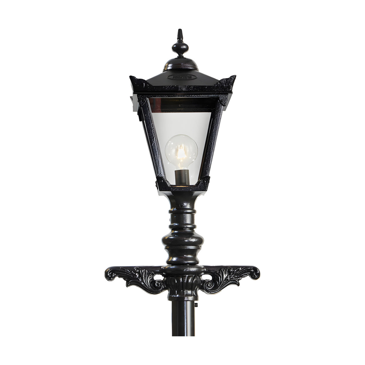 Victorian cast iron lamp post in black with a tapered four-sided glass lantern head, cast finial, decorative scroll bracket base, and visible bulb, shown against a plain white background.